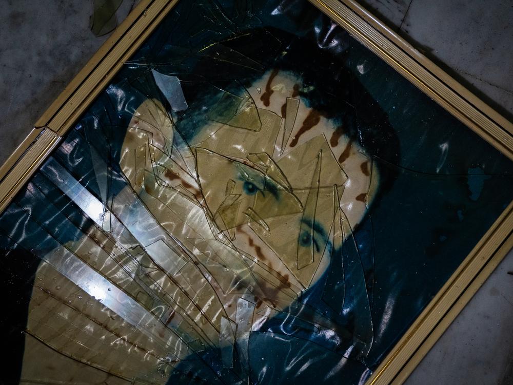 A picture of Assad lies shattered on the floor of the former Air Force Intelligence building in Damascus.