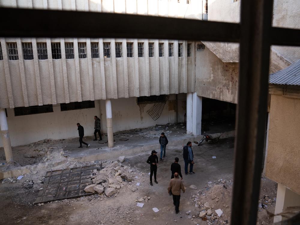 People looking for missing family members walk through Sednaya prison, just North of Damascus, where the Assad regime detained and tortured people.