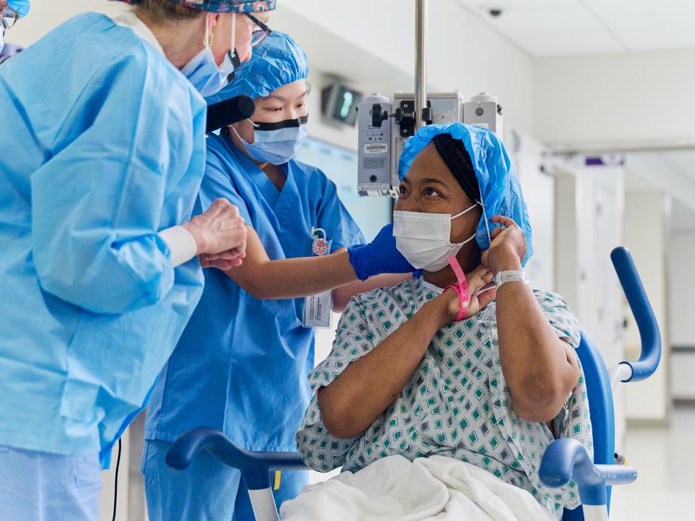 Towana Looney, 53, of Gadsden, Ala., gets ready to head into the operating room at NYU Langone Health in New York City to get a genetically modified pig kidney transplant. Looney, who's devoutly religious, says she sang church hymns the night before the surgery. But she had no doubts about trying this experimental surgery.