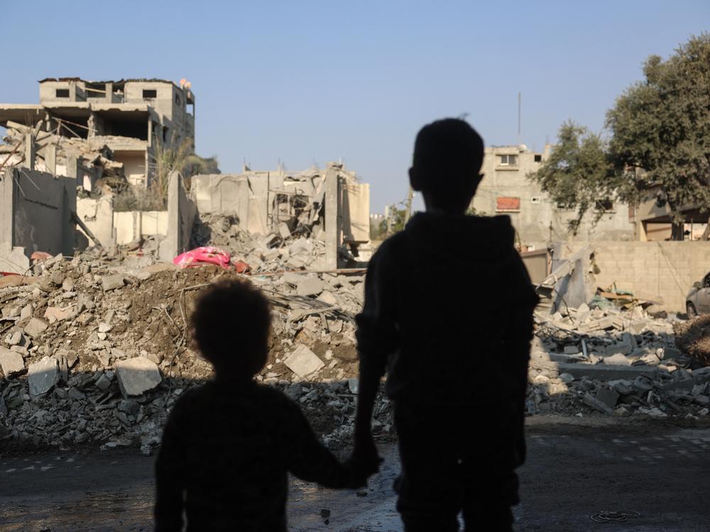 Children stare at the destruction following an Israeli strike in the Nuseirat refugee camp in the central Gaza Strip on Thursday.