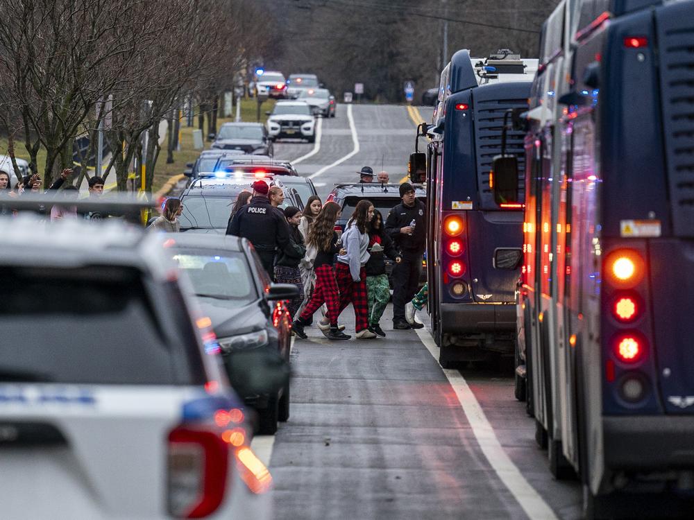 Emergency vehicles are parked outside the Abundant Life Christian School in Madison, Wis., where multiple injuries were reported following a shooting on Monday.