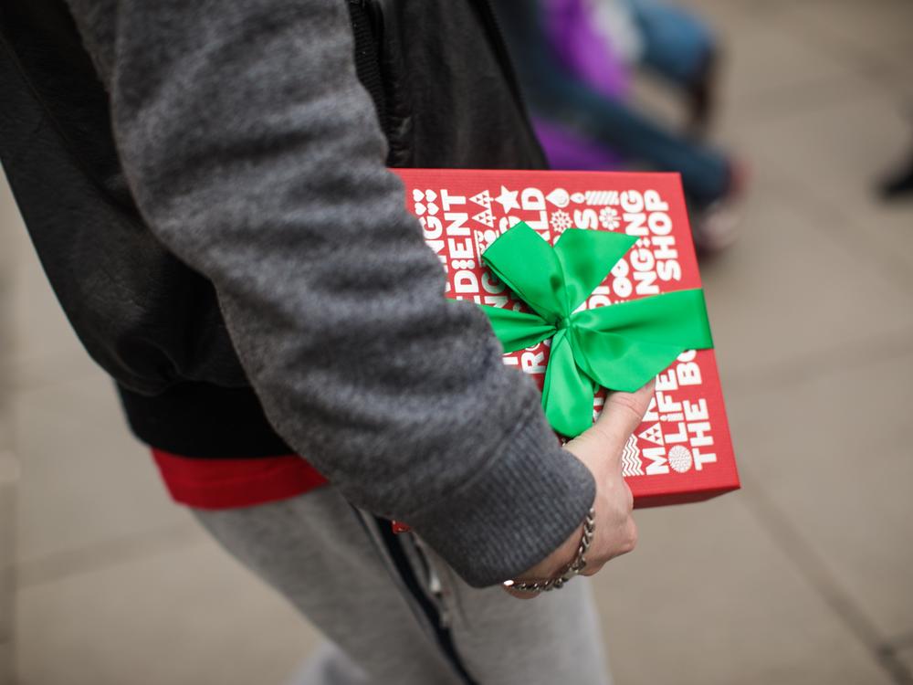 A man carries a gift-wrapped box on Oxford Street on December 24, 2016 in London, England. Christmas shoppers hunt for last minute presents in central London on Christmas Eve.