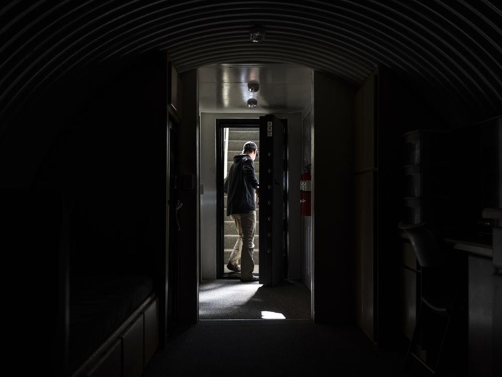 The owner, who asked not to be identified because of concerns about his privacy, closes the heavy metal door of his underground shelter in an undisclosed Southern California city, Monday, Dec. 16, 2024.