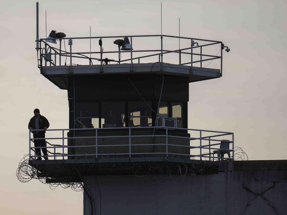 A guard stands in a tower at Indiana State Prison on Tuesday, Dec. 17, 2024, in Michigan City, Ind., where, barring last-minute court action or intervention by Gov. Eric Holcomb, Joseph Corcoran, 49, convicted in the 1997 killings of his brother and three other people, is scheduled to be put to death by lethal injection before sunrise on Wednesday.