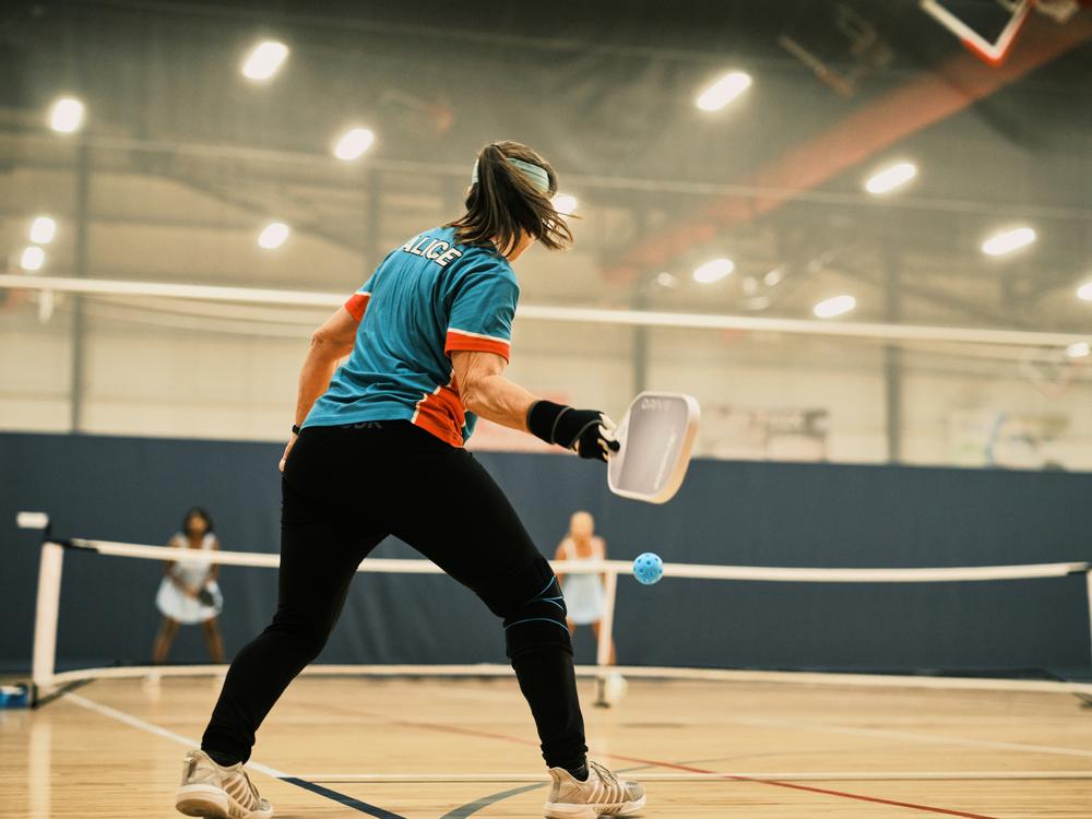 Pickleball player Alice Edington, 56, returns the ball to her opponents during a doubles match at the Florida Senior Games. Pickleball is the fastest-growing sport and it's also popular with older athletes.