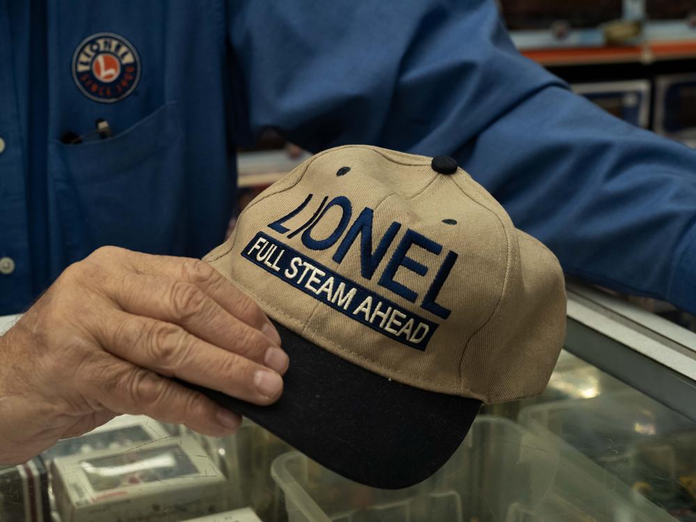 An employee shows a custom-made Lionel train hat at Trainland on National Lionel Train Day.