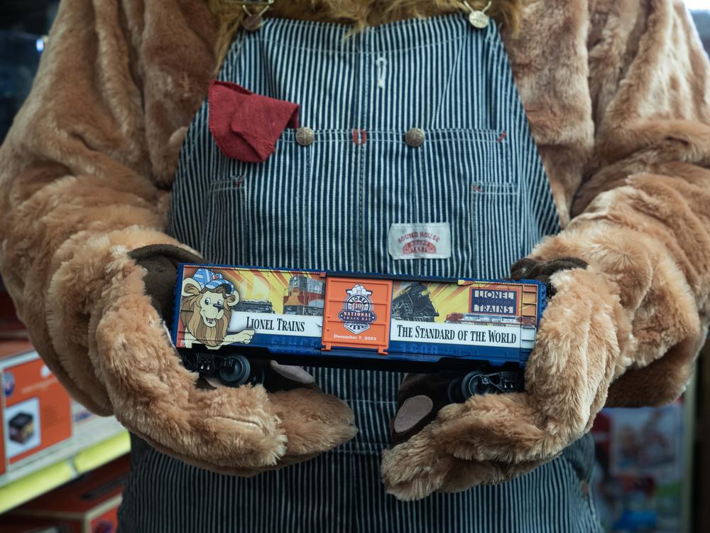 The Lionel train mascot Lenny holds special edition Lionel boxcar at TrainLand in Lynbrook, New York.