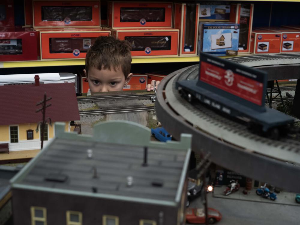 Four-year old train collector Augie DiMartino watches the trains go by at Trainland on National Lionel Train Day.