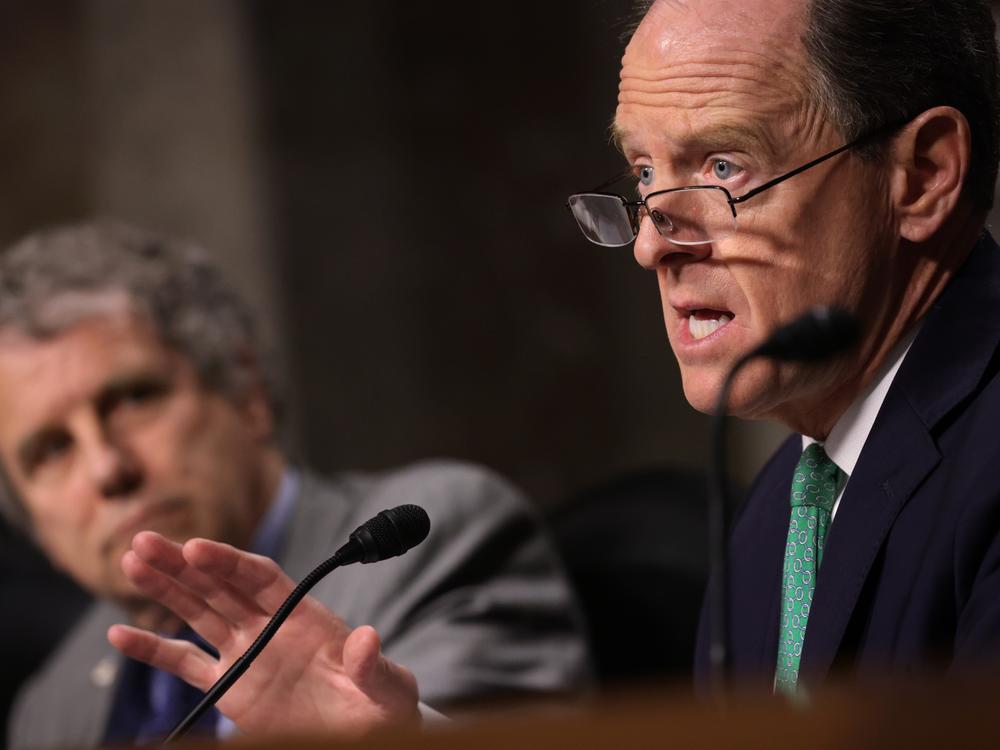 On Dec. 14, 2022, Sen. Pat Toomey, R-Pa., speaks as Sen. Sherrod Brown, D-Ohio, listens during a hearing before the Senate Banking Committee.