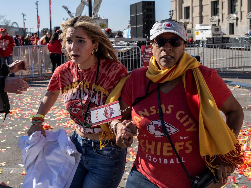 People flee after shots were fired near the Kansas City Chiefs' Super Bowl victory parade. Police said a dispute between several people ended in gun violence.