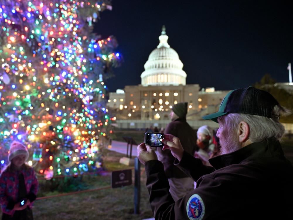 The Christmas tree outside the U.S. Capitol is illuminated as Congress works to finalize a stop-gap spending bill to avoid a government shutdown.