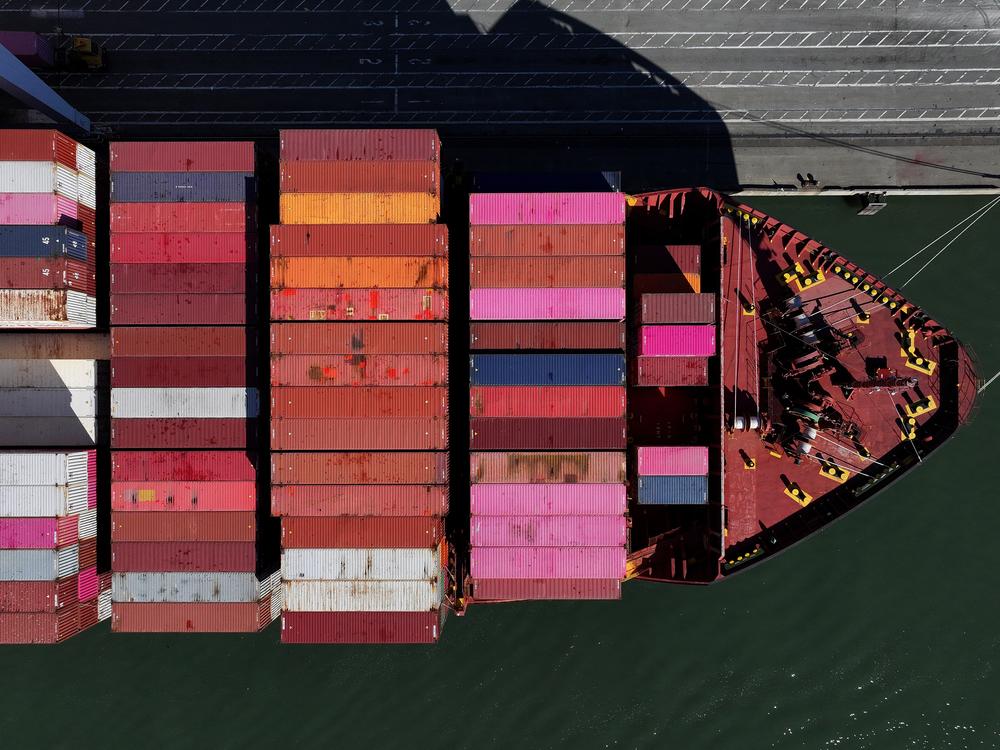 A container ship sits docked at the Port of Oakland in California on Dec. 9. President-elect Donald Trump is threatening new tariffs on multiple countries as his second term approaches, after making tariffs a signature of his 2024 presidential campaign.