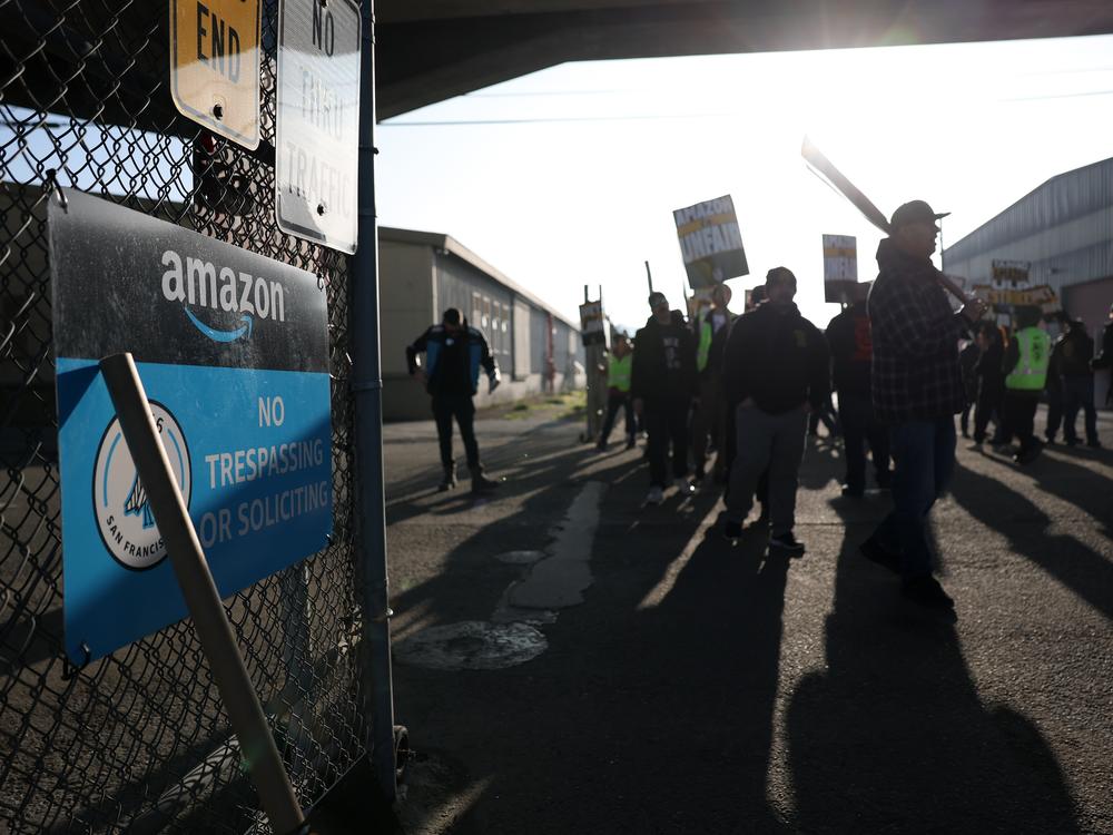 Teamsters union workers picket outside an Amazon distribution center in San Francisco on Thursday.