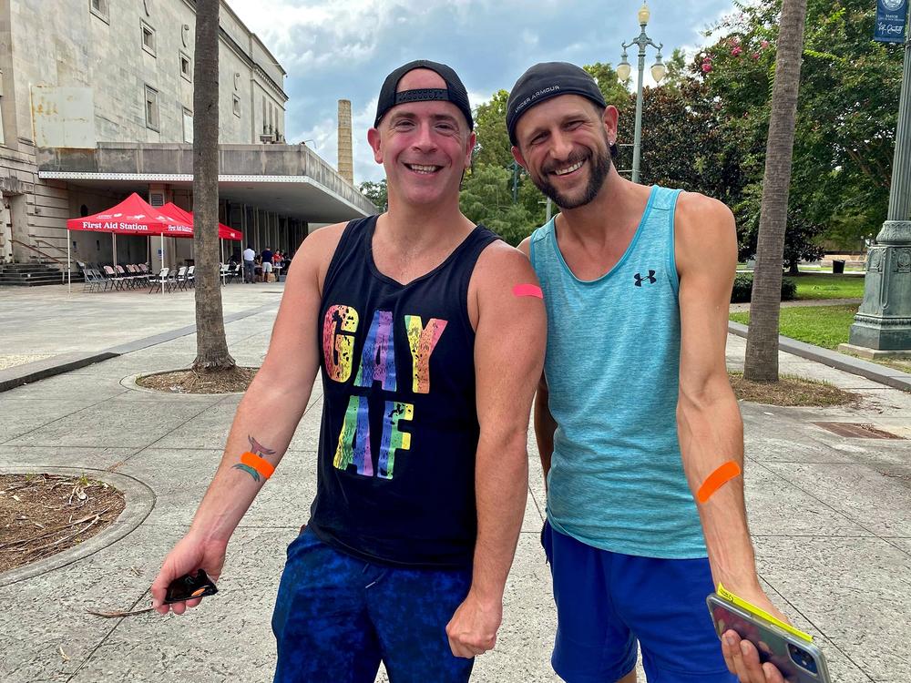 In this file photo, Anthony Reed (left) and Christopher Bowles (right) show the Band-Aids they got after receiving the mpox vaccine at the Southern Decadence Health Hub in New Orleans on Sept. 4, 2022. The health hub, at the annual LGBTQ celebration, was organized by the Louisiana Department of Health. <br>