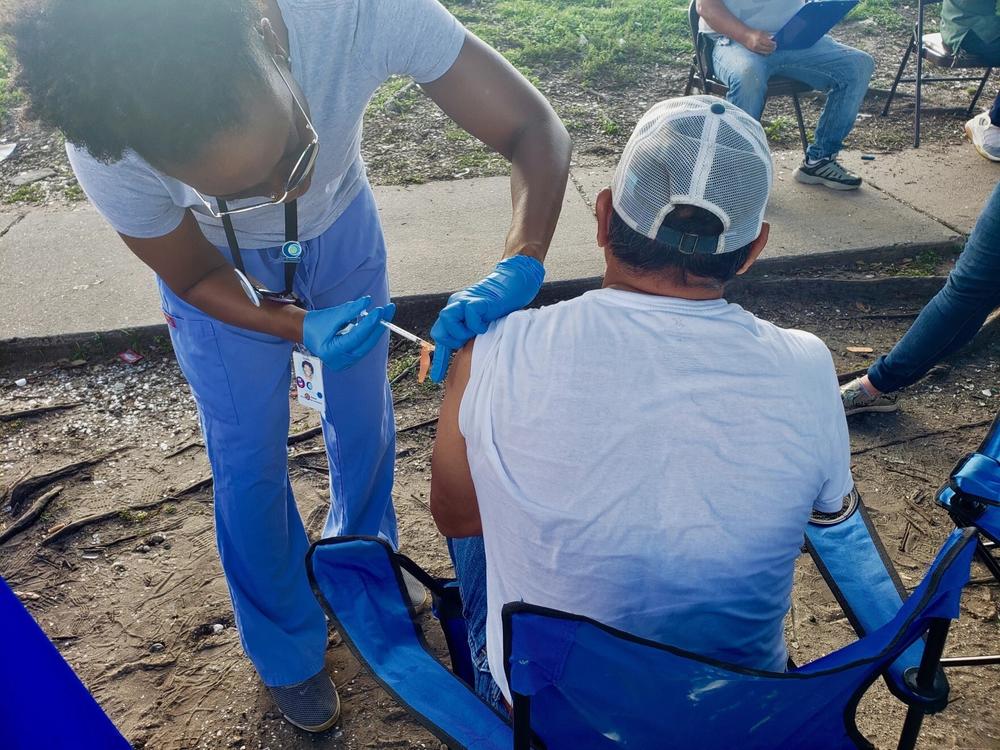 Physician assistant Danis Walker vaccinates a construction worker outside a Lowes Home Improvement store in New Orleans on June 11, 2021.