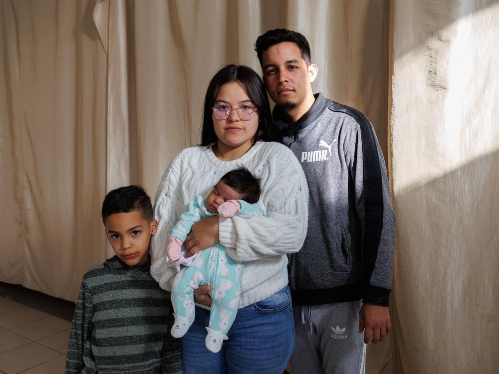 Venezuelans Ricardo Bravo, 29, his wife Bárbara Mendoza, 28, their son Mathias Mendoza, 6, and one-month-old daughter Sáhira Bravo pose for a portrait inside of El Buen Samaritano migrant shelter in Ciudad Juárez, Chihuahua state, Mexico on Sunday, December 8, 2024.