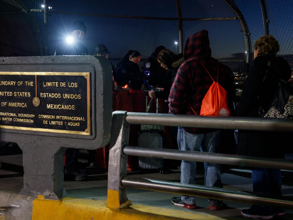 Migrants with CBP One appointments have their paperwork checked by CBP agents atop the Paso del Norte International Bridge before being allowed to cross into the United States, in Ciudad Juárez, Chihuahua state, Mexico on Monday, December 9, 2024.