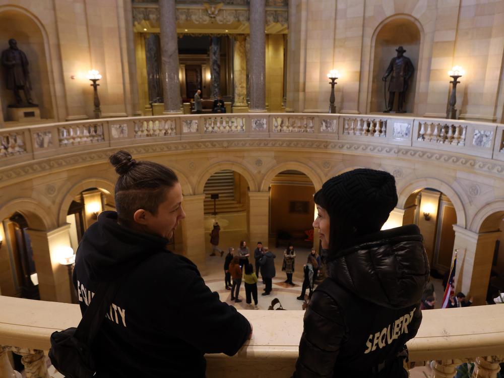 Sam Koshiol-Wright, left, and Aleksi Brown talk after a press conference the group Sequeerity monitored for any confrontations at the Minnesota State Capitol in Saint Paul, Minn., Dec. 3.
