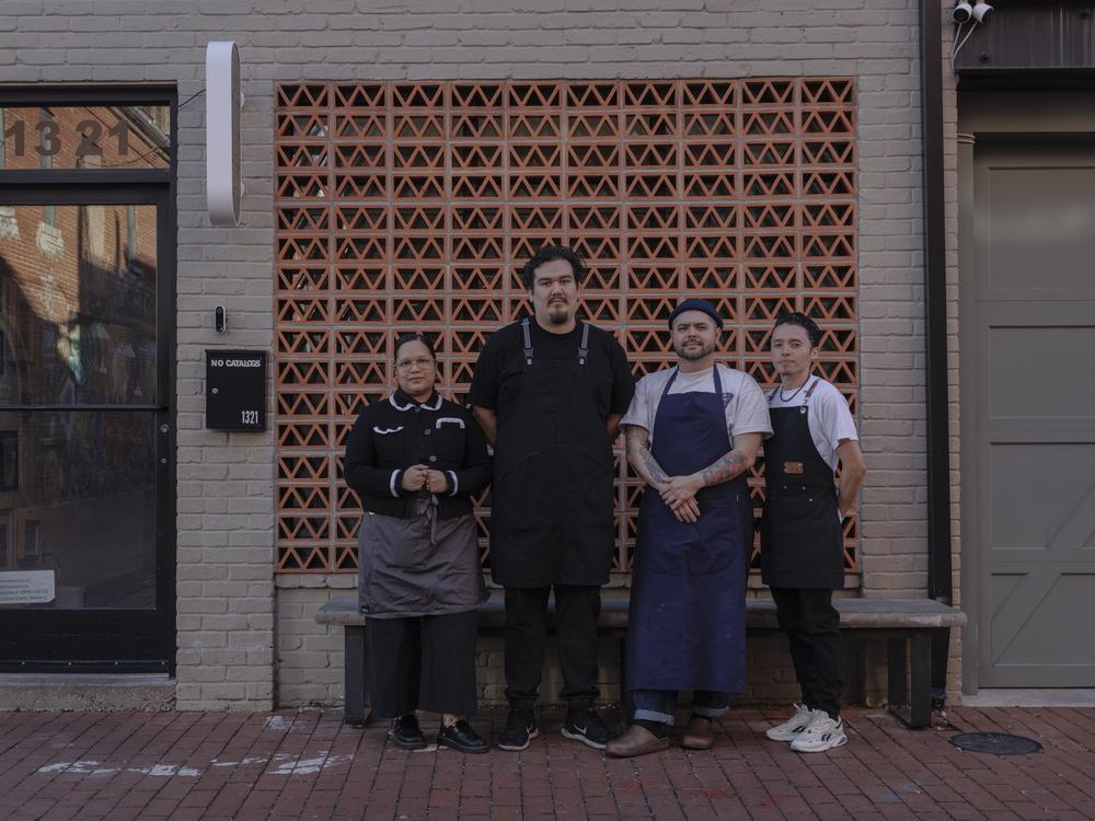 From left to right, Paola Velez, Pedro Tobar, Erik Bruner-Yang and Daniel Gonzalez pose for a photo outside the newly opened alley bar Providencia in Washington, D.C., on Dec. 12.