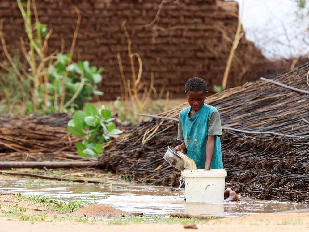 A displaced Sudanese child pours water at Zamzam camp in Darfur, Sudan, Aug. 1. Famine was confirmed in the camp that same month.