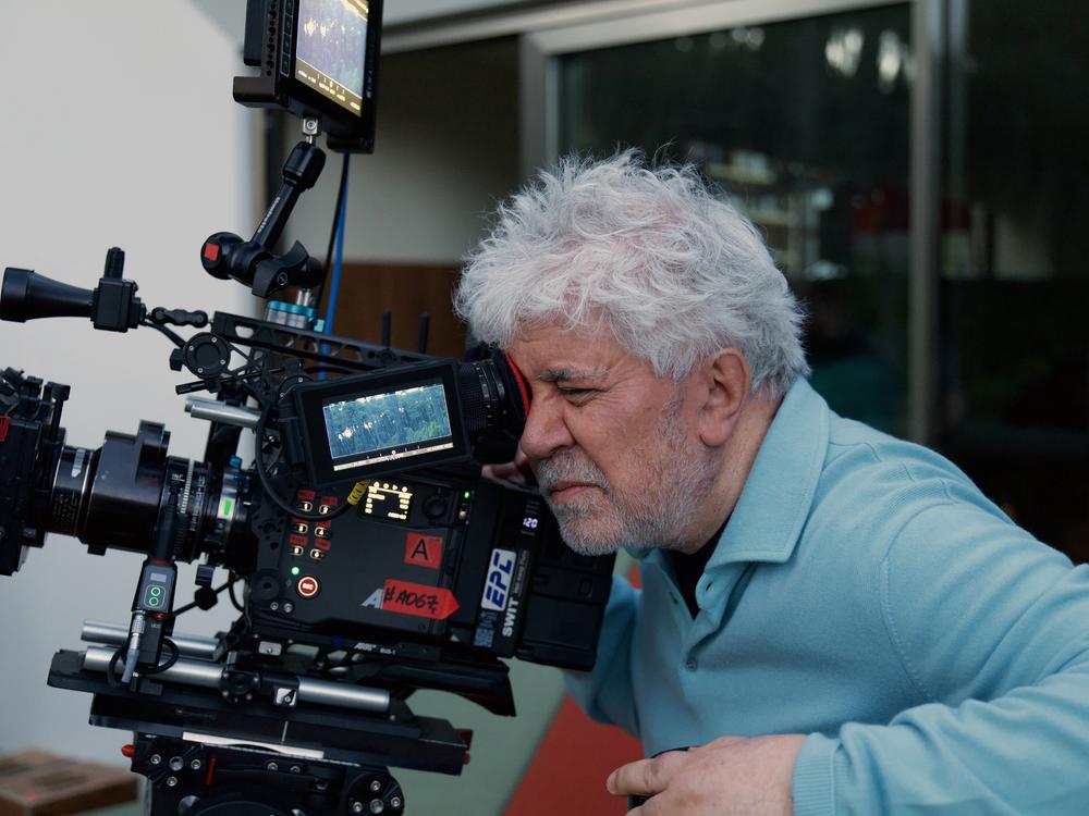 Director Pedro Almodóvar operates a camera on the set of <em>The Room Next Door</em>
