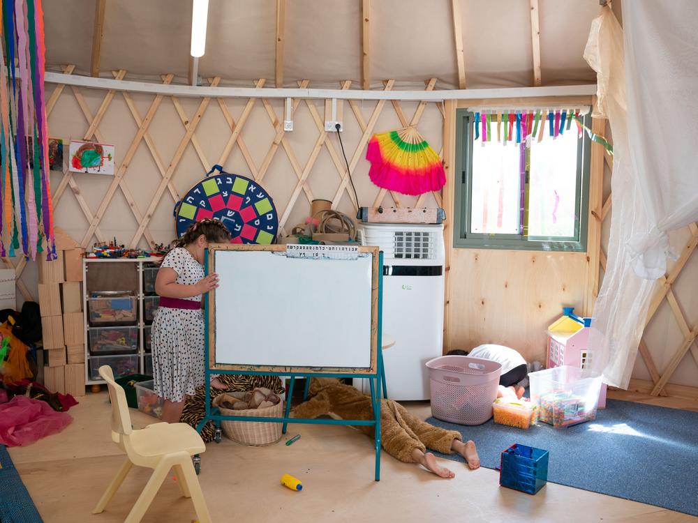 Children play in a temporary classroom built for the evacuated residents of Kibbutz Be'eri.
