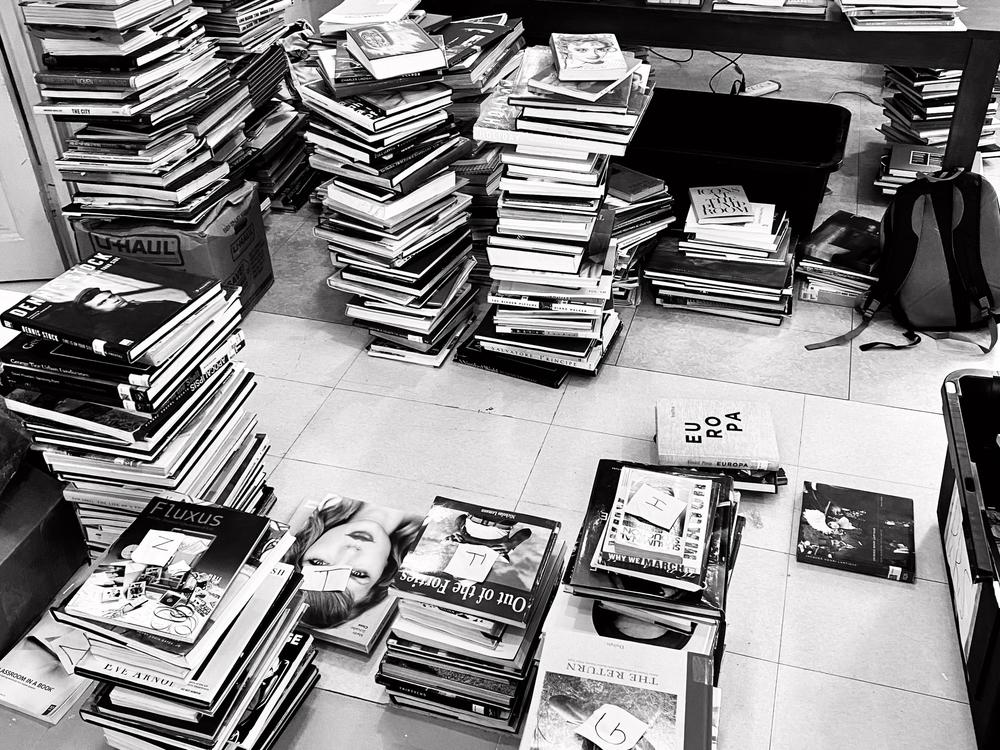 Staff members at the Dikan Center sort and label books in June 2022 as they prepared for the library's opening at the end of the year.
