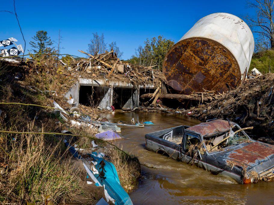 Little Crabtree Creek is littered with storm debris and vehicles, on Thursday, Oct. 17, 2024, three weeks after Hurricane Helene flooded the South Toe River and adjacent creeks near Micaville in Yancey County, N.C.