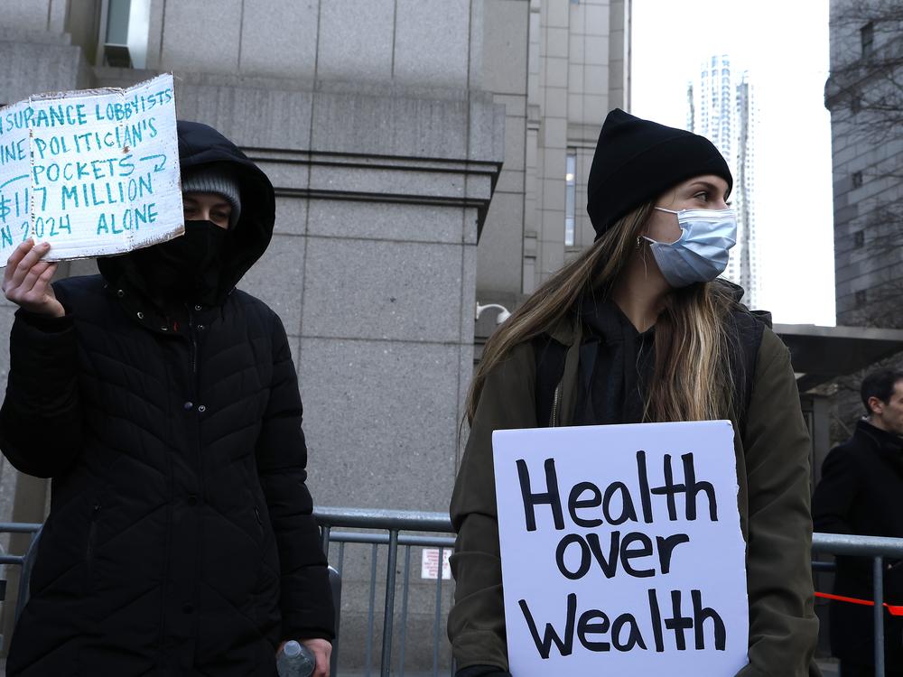 People demonstrating against the health care industry stand outside Federal Criminal Court as Luigi Mangione, suspect in the shooting death of UnitedHealthcare CEO Brian Thompson, appears during an arraignment hearing on Dec. 19, 2024 in New York City.