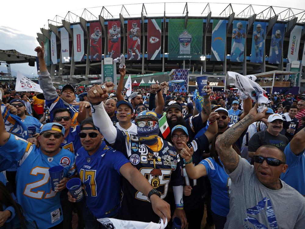 Fans cheer before an NFL football game between the Los Angeles Chargers and the Kansas City Chiefs in Mexico City in 2019. The NFL plans to play as many as eight international games beginning next season. The NFL's two largest international markets are Mexico and Brazil,