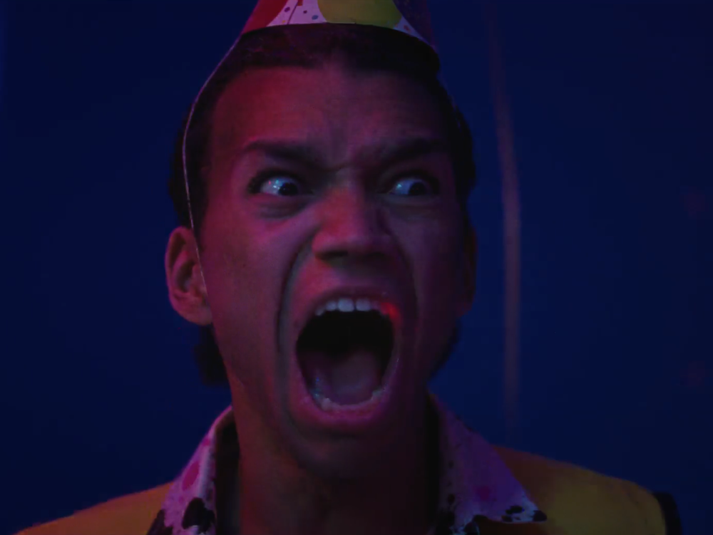 Owen (Justice Smith) panics at a child's birthday party at the end of <em>I Saw the TV Glow</em>.