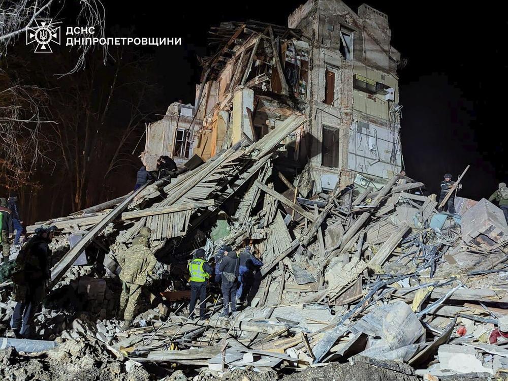 In this image provided by the Ukrainian Emergency Service on Wednesday, firefighters work on a site of an apartment building destroyed by a Russian attack in Kryvyi Rih, Ukraine.