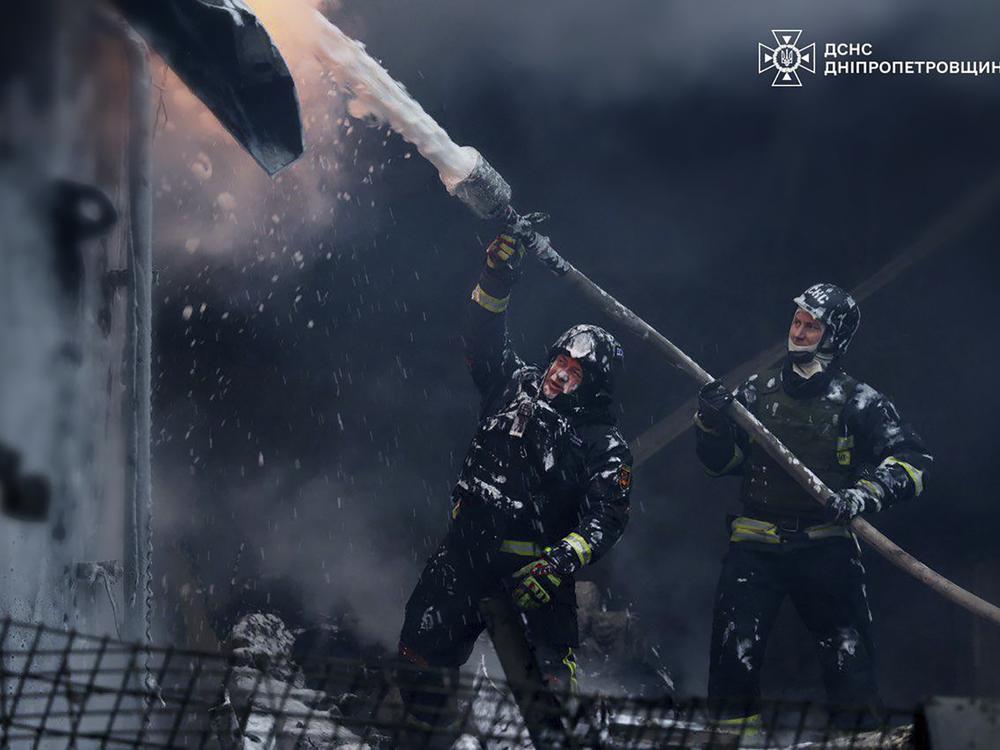 In this image provided by the Ukrainian Emergency Service, firefighters put out a fire following a Russian missile attack on the country's energy system in Dnipropetrovsk region, Ukraine, on Wednesday.