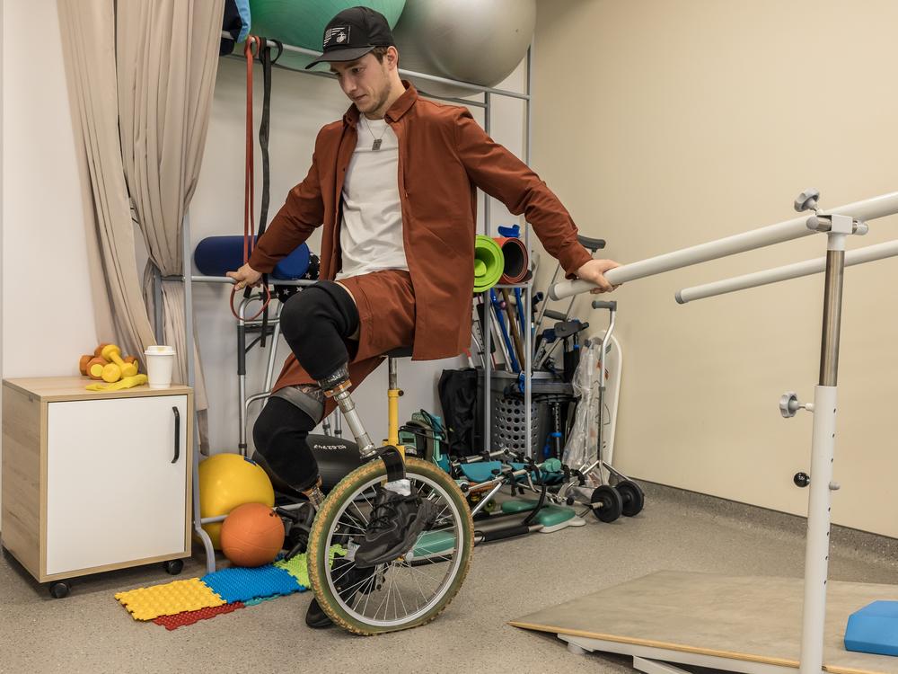 Oleksandr Budko tries to ride a unicycle at the Recovery rehabilitation center in Kyiv, Ukraine, on Oct. 18. He goes to rehabilitation centers to share the information on the process of his recovery, logistics to obtain prosthetics and about the possibilities for injured veterans.