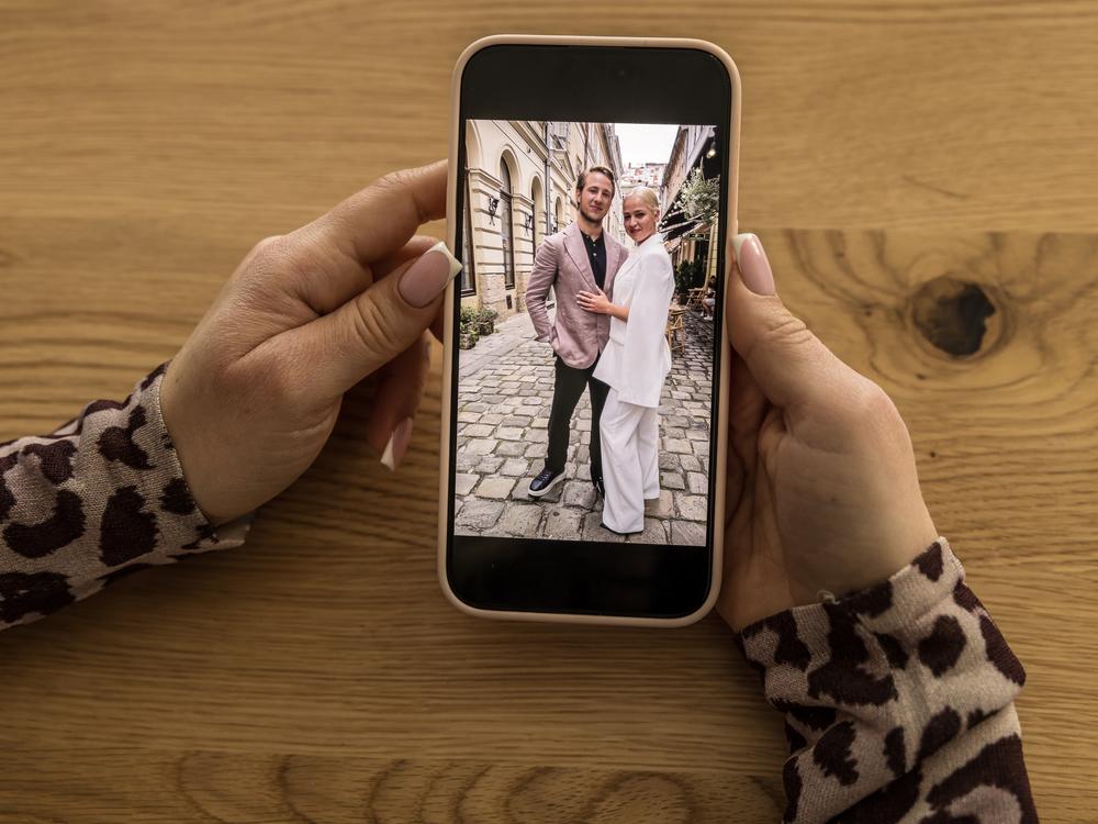 Inna Bielien, 29, German language translator who is a contestant on the Ukrainian version of the TV show <em>The Bachelor</em>, shows a photo from behind the scenes of show, in Kyiv, Ukraine, on Dec. 13.