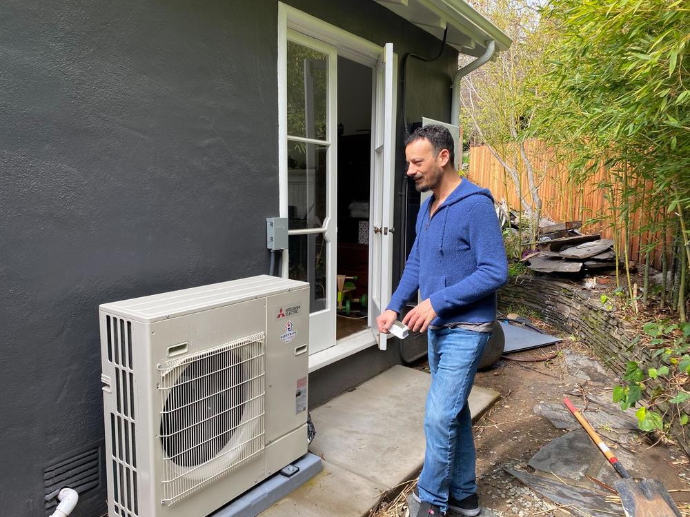 James Tucker with an efficient heat pump for his home near Oakland, Calif.