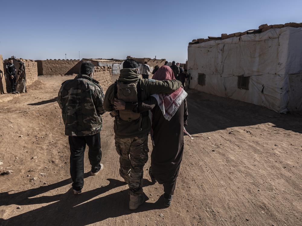 Syrians in the Rukban camp for displaced people, including members of the U.S.-backed Syrian Free Army, walk along a road in the camp, on Dec. 14.