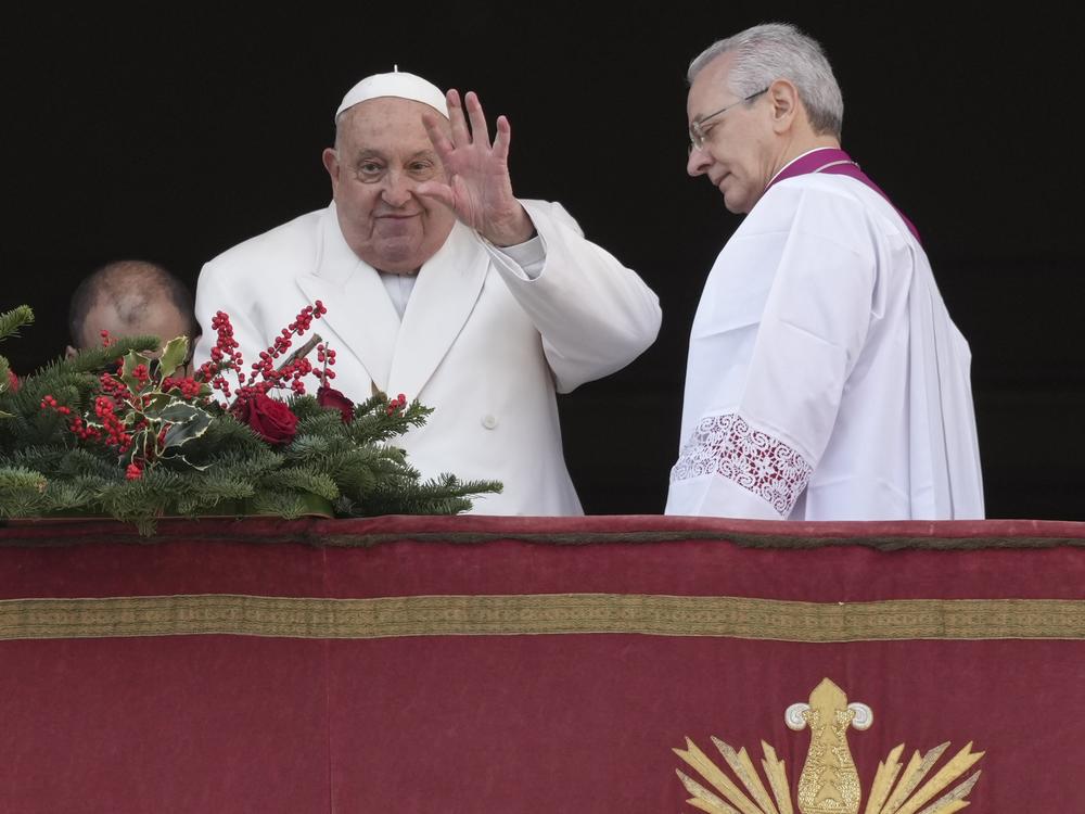 Pope Francis waves before delivering the Urbi et Orbi (Latin for 'to the city and to the world' ) Christmas' day blessing from the main balcony of St. Peter's Basilica at the Vatican, Wednesday, Dec. 25, 2024.