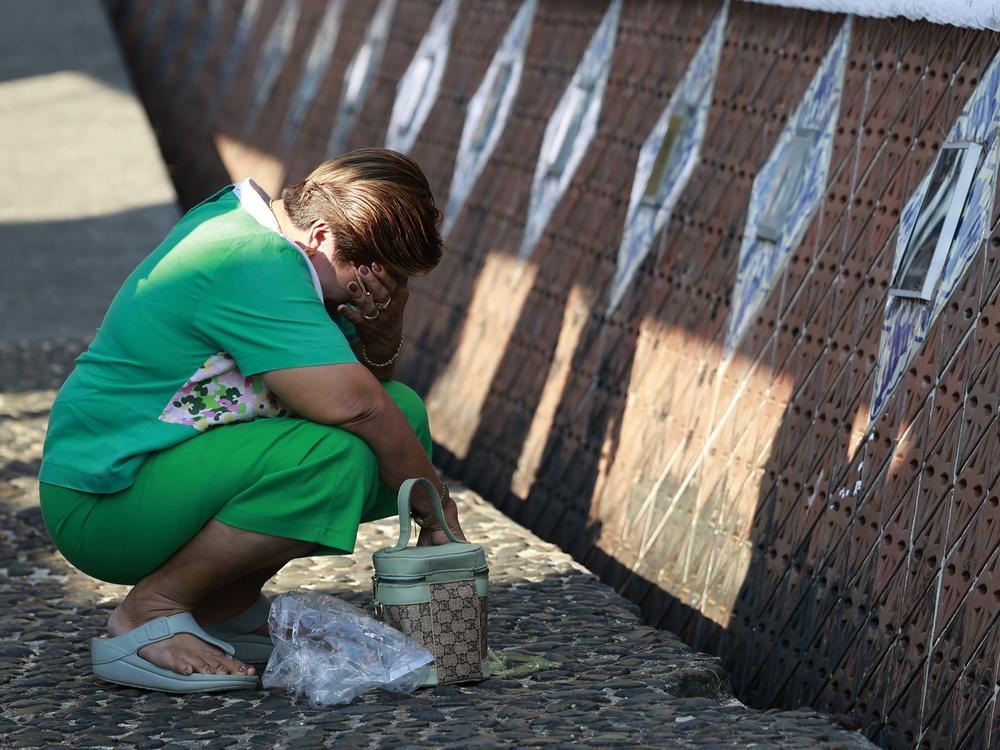 A relative of a tsunami victim cries at Tsunami Memorial Park on Thursday.