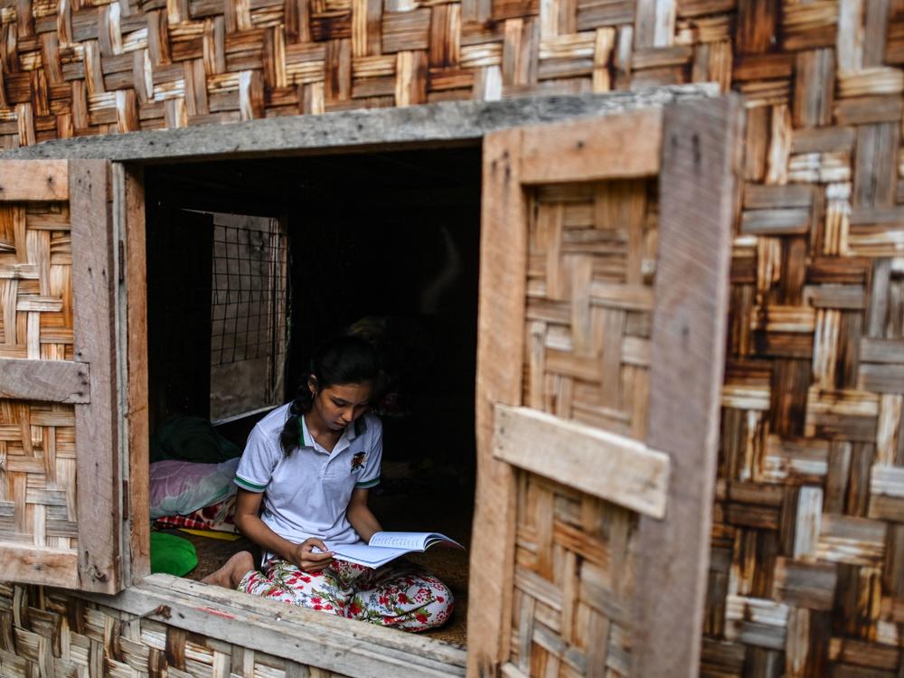 This photo taken on June 20, 2020 shows 18-year-old Muslim May Thandar Maung, who says she hasn't been able to get an ID card because of her religion and hence unable to vote in the upcoming election, studying Arabic and religion in her home in Meiktila, Mandalay Region.