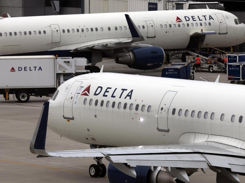 FILE - A Delta Air Lines plane leaves the gate July 12, 2021, at Logan International Airport in Boston. A Delta flight from Seattle to Honolulu was delayed on Tuesday afternoon after an unticketed passenger was discovered onboard the aircraft.
