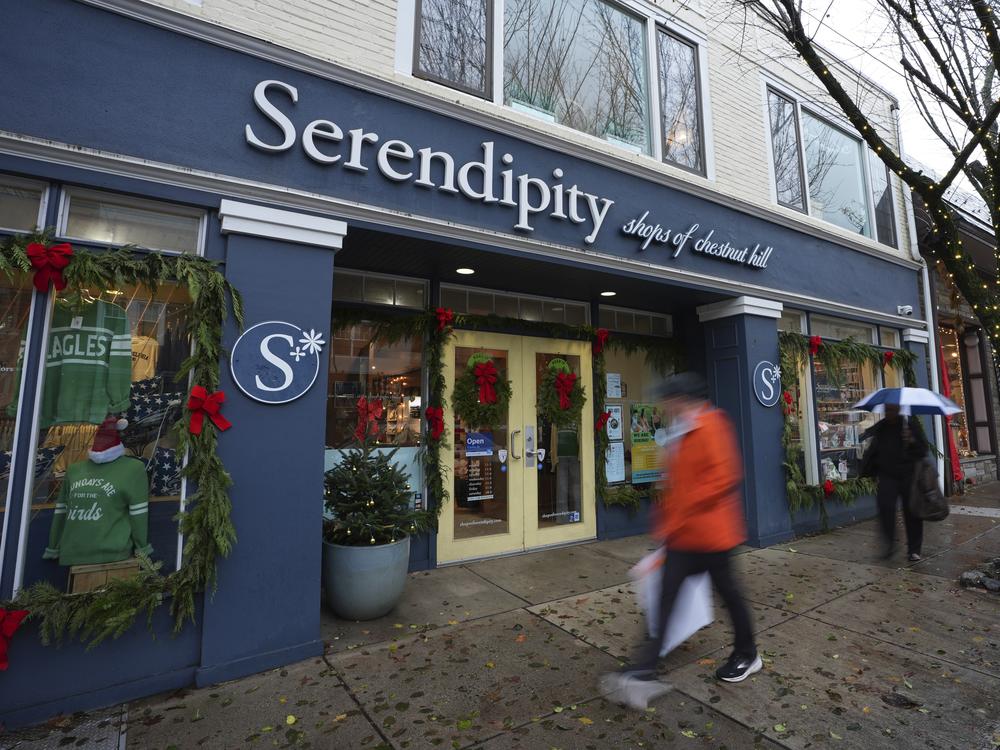 People walk past shops on Dec. 11 in Philadelphia.