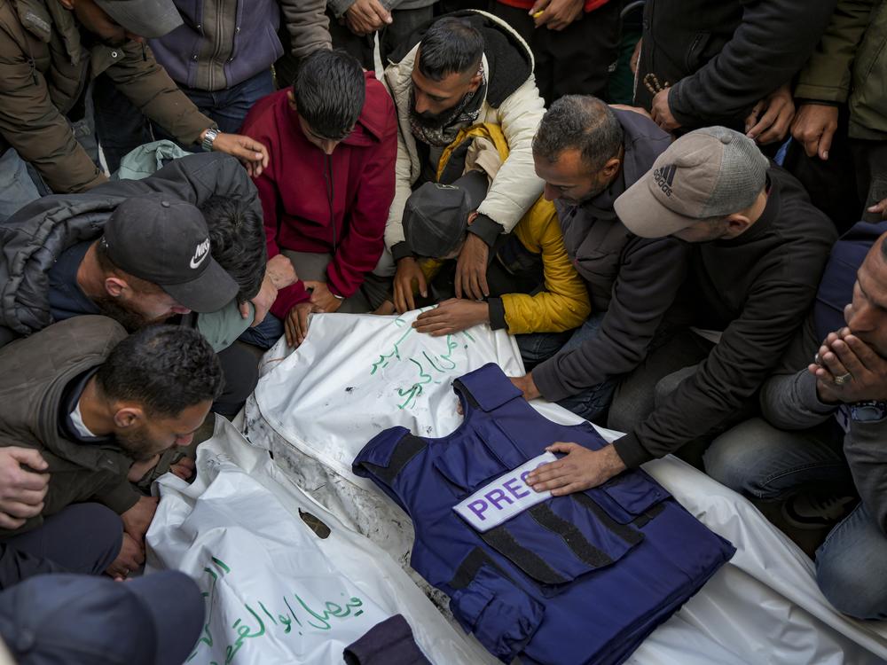 Relatives and friends mourn over the bodies of five Palestinian journalists who were killed by an Israeli airstrike in Gaza City at the Al-Aqsa Hospital in Deir al-Balah, on Thursday.