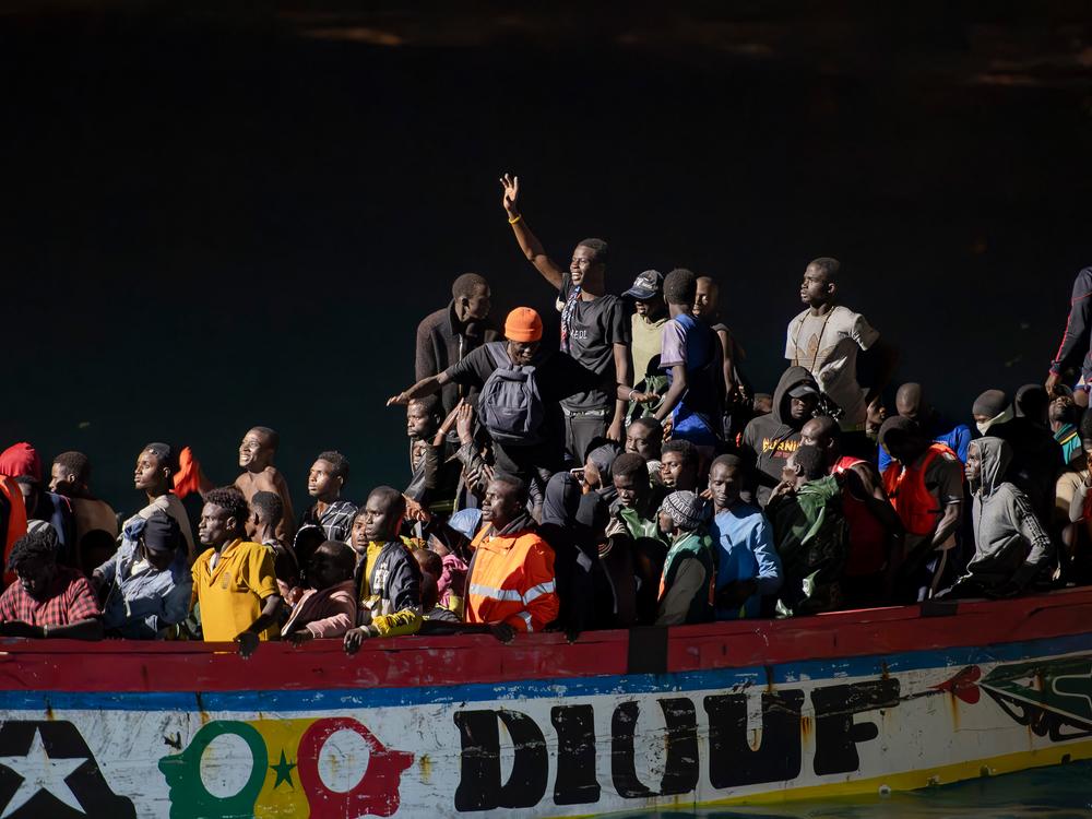 Migrants on a <em>cayuco</em> boat arrive to disembark at La Restinga port on the Canary island of El Hierro, in September.