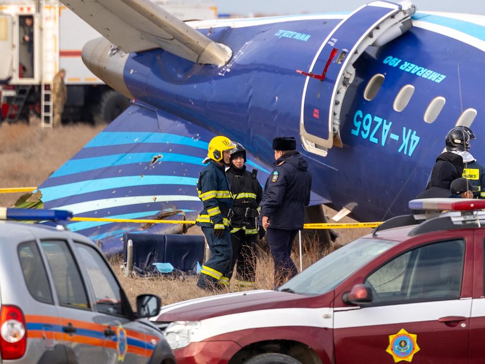 Emergency specialists work at the crash site of an Azerbaijan Airlines passenger jet near the western Kazakh city of Aktau.