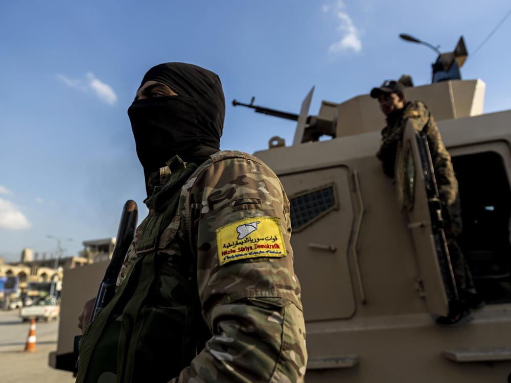U.S.-backed Syrian Democratic Forces (SDF) fighters stand guard at Al Naeem Square in Raqqa, Syria, in February 2022.