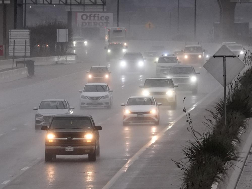 Vehicles make their way on a rain soaked highway in Dallas on Thursday.
