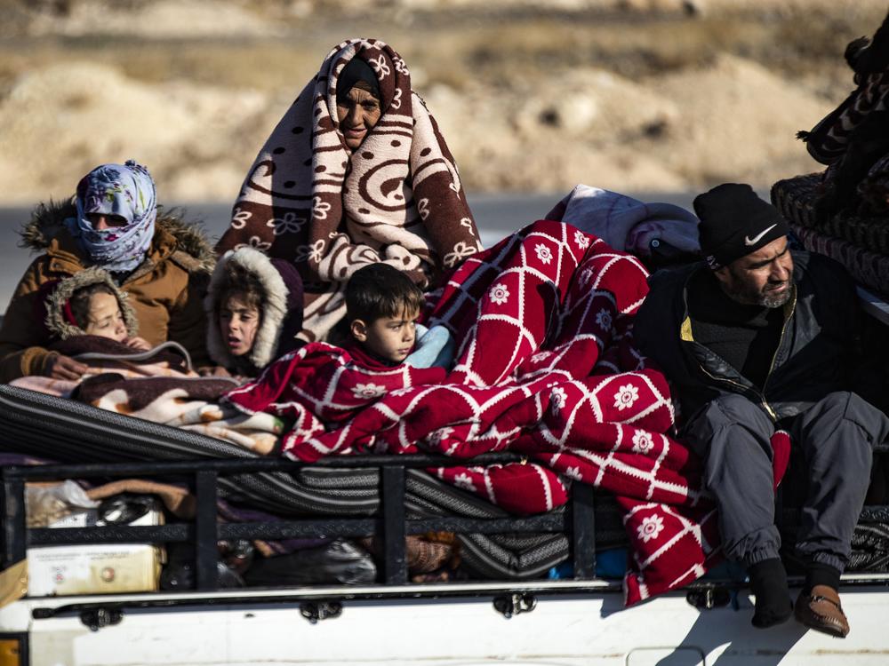 Syrian Kurds fleeing areas north of Aleppo, Syria, arrive in Tabaqah, on the western outskirts of Raqqa, on Dec. 3.