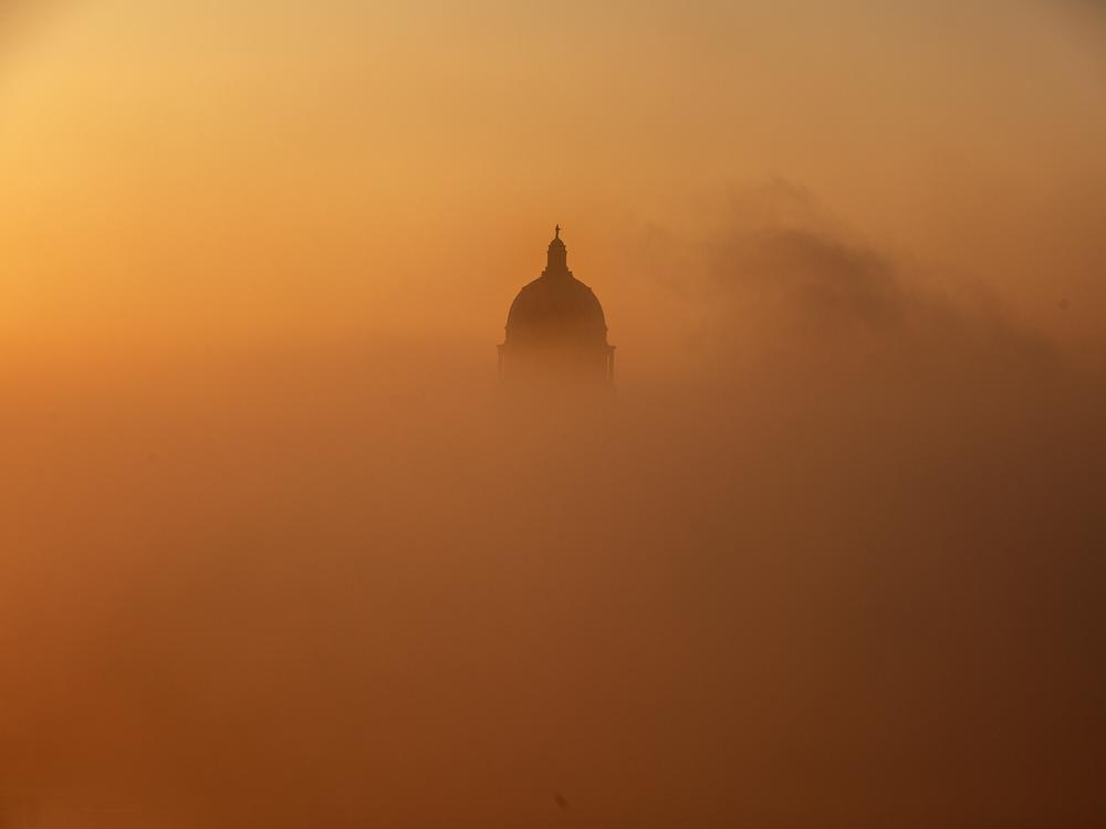 Fog rises off the Missouri River in front of the Missouri state Capitol building on the morning of Jan. 3, in Jefferson City, Mo.