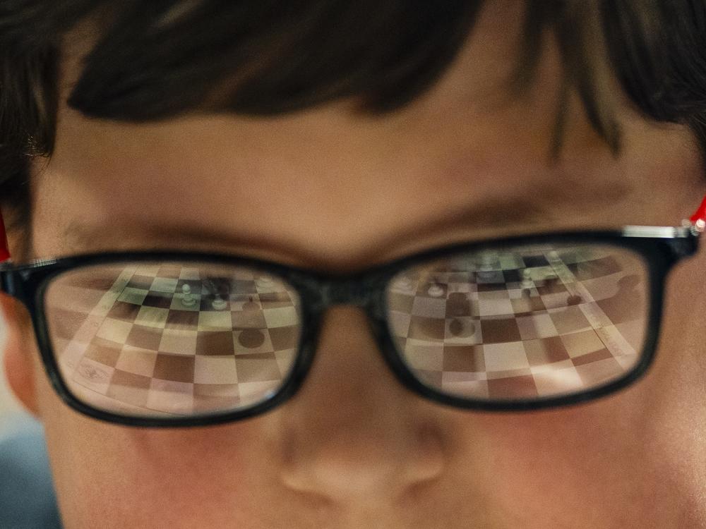 A student analyzes a chess board during the St. Louis Public Schools' annual chess tournament on May 10 at St. Louis Science Center in St. Louis' Kings Oak neighborhood. Full story <a href=